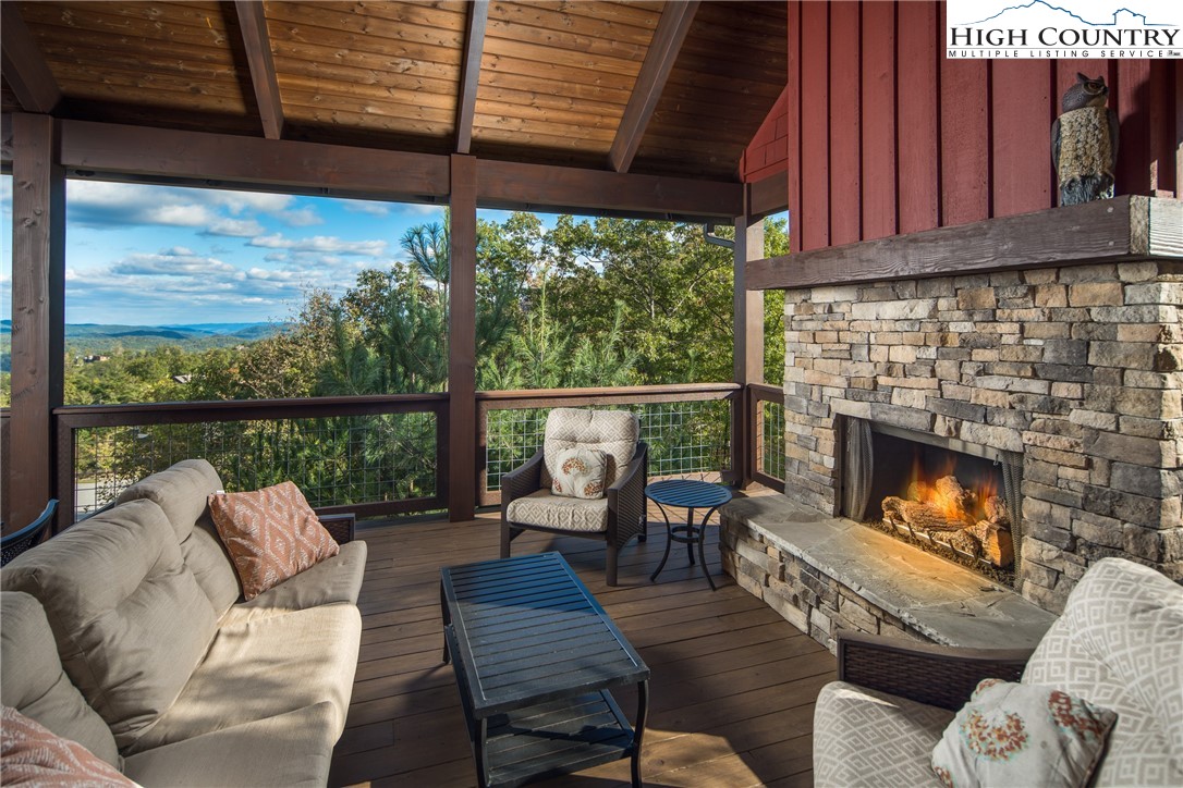 1253 Goldenrod Road Boone, NC 28607 - Photo 11 of 48 a balcony with furniture and a fireplace