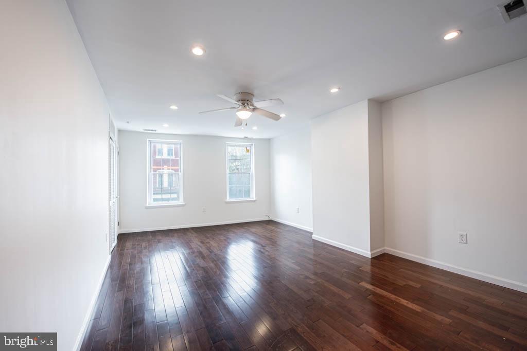545 Christian Street, Unit 2 Philadelphia, PA 19147 - Photo 12 of 30 a view of an empty room with wooden floor and a window