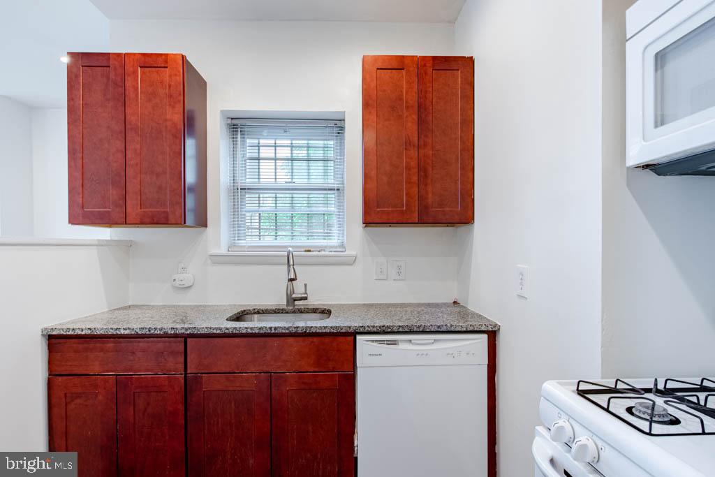 545 Christian Street, Unit 2 Philadelphia, PA 19147 - Photo 13 of 30 a kitchen with stainless steel appliances granite countertop a sink stove and cabinets
