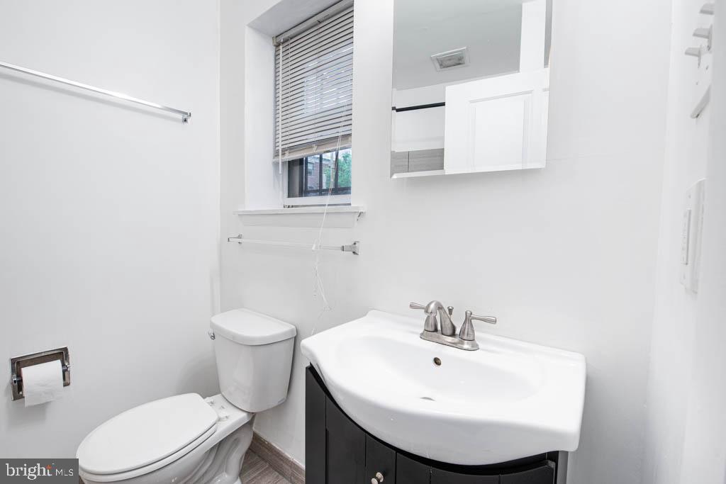 545 Christian Street, Unit 2 Philadelphia, PA 19147 - Photo 21 of 30 a bathroom with a sink a mirror and a toilet