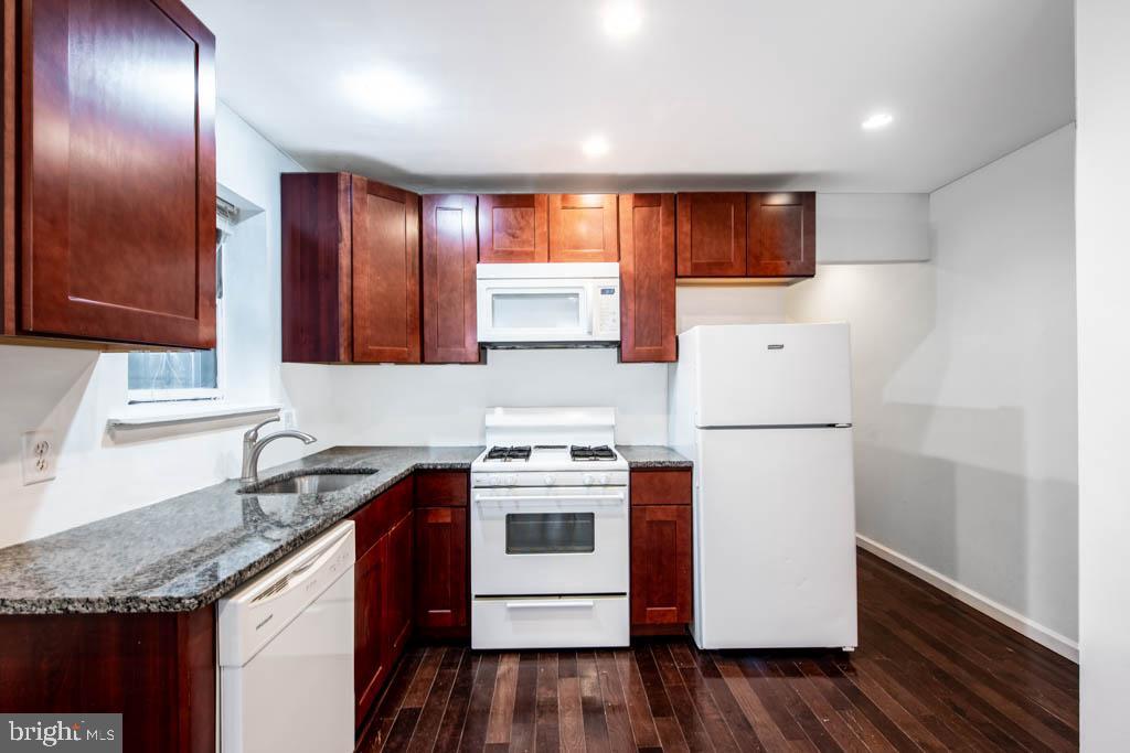 545 Christian Street, Unit 2 Philadelphia, PA 19147 - Photo 24 of 30 a kitchen with a sink a stove a refrigerator and cabinets