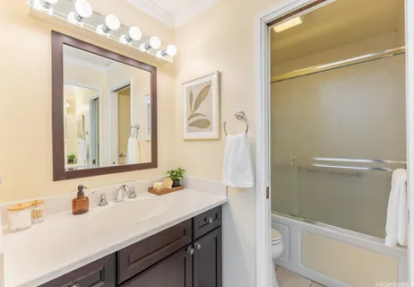 a bathroom with a sink vanity tub and a mirror