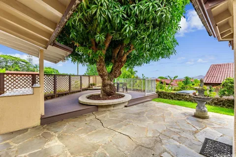 a view of a backyard with plants and a patio