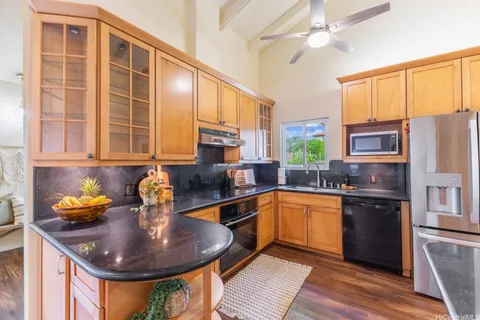 a kitchen with stainless steel appliances granite countertop a sink a stove and refrigerator
