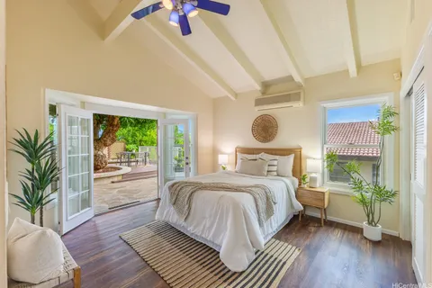 a bedroom with a large bed and a large window