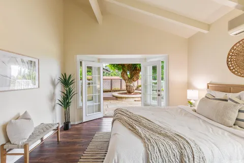 a bedroom with furniture and a large window