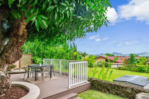 a view of a chairs and table in backyard