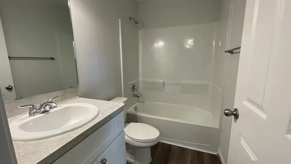 a bathroom with a sink toilet tub and shower