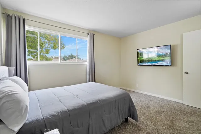 a bedroom with a large bed and a window