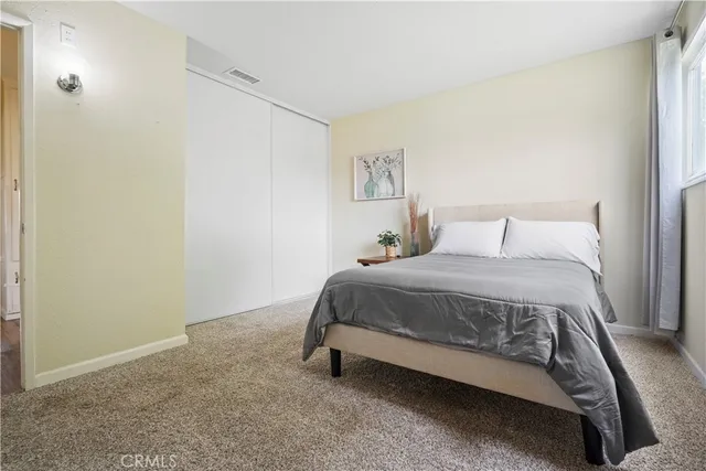 a bedroom with a bed and a night stand