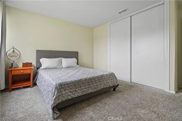 a bedroom with a bed and a night stand