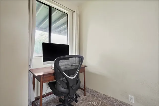a view of workspace with wooden floor windows