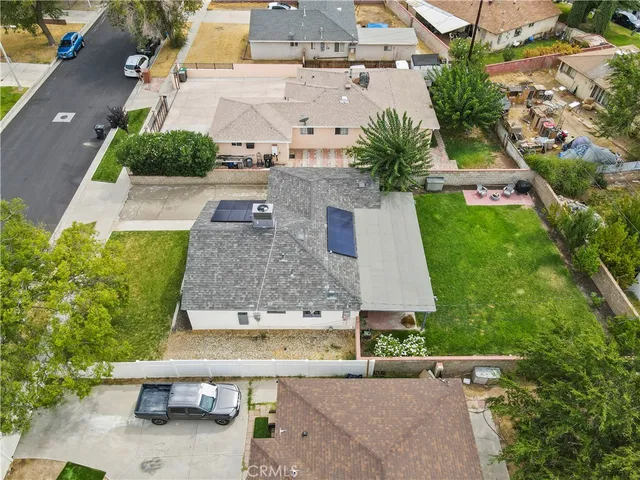 an aerial view of a house with yard swimming pool and outdoor seating