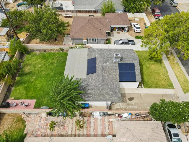 a aerial view of a house with a yard and seating space