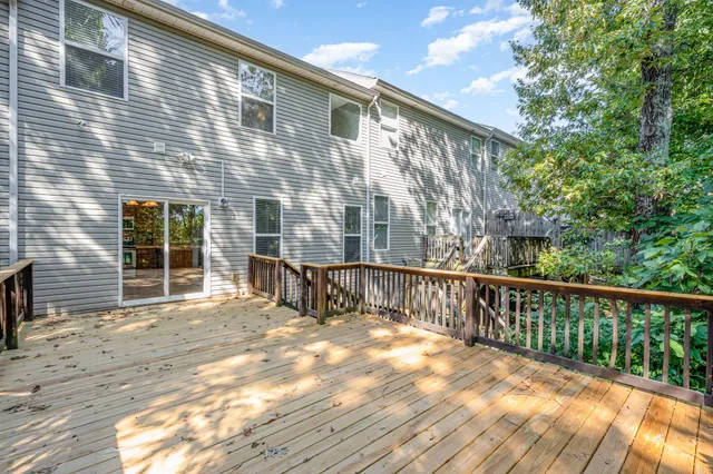 a view of a house with a wooden fence