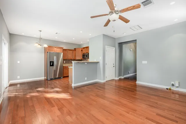 a view of a kitchen with a sink and a refrigerator