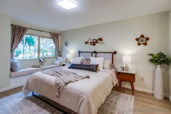 a bedroom with a bed and a potted plant