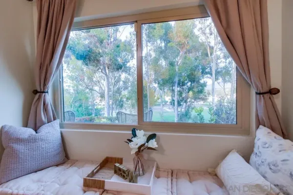 a bath tub sitting in a living room next to a window