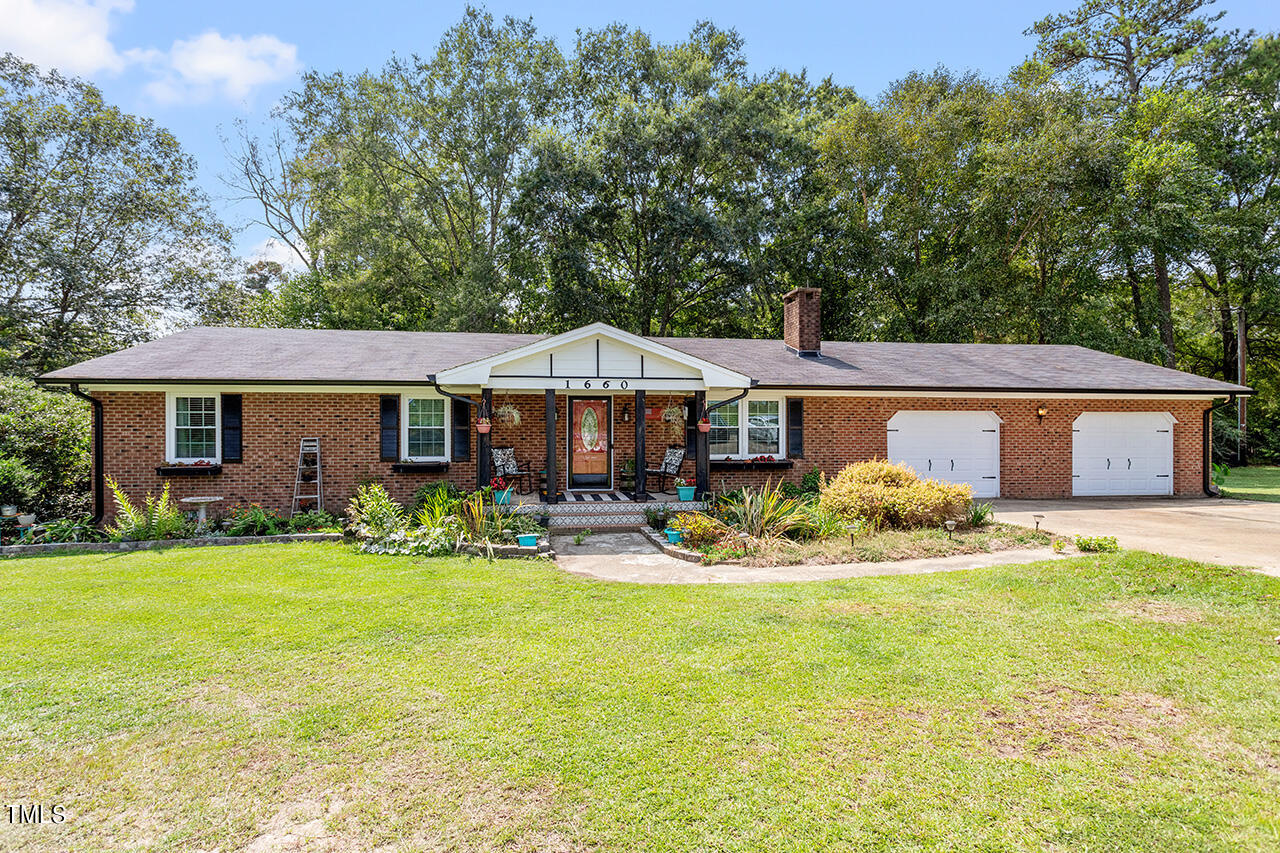 1660 Benson Road Angier, NC 27501 - Photo 1 of 32 a front view of house with yard patio and fire pit