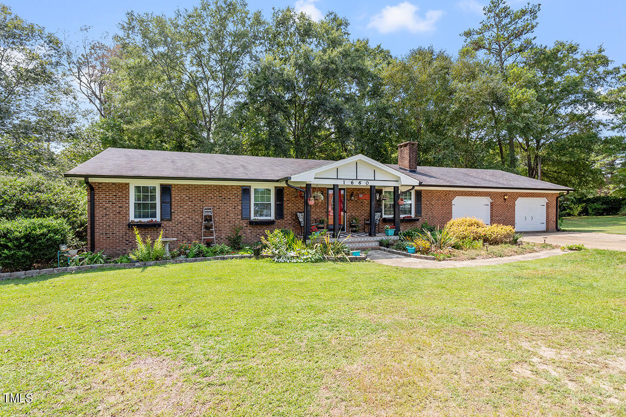 1660 Benson Road Angier, NC 27501 - Photo 2 of 32 a front view of a house with garden