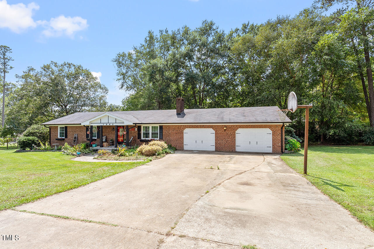 1660 Benson Road Angier, NC 27501 - Photo 3 of 32 a front view of a house with yard porch and green space