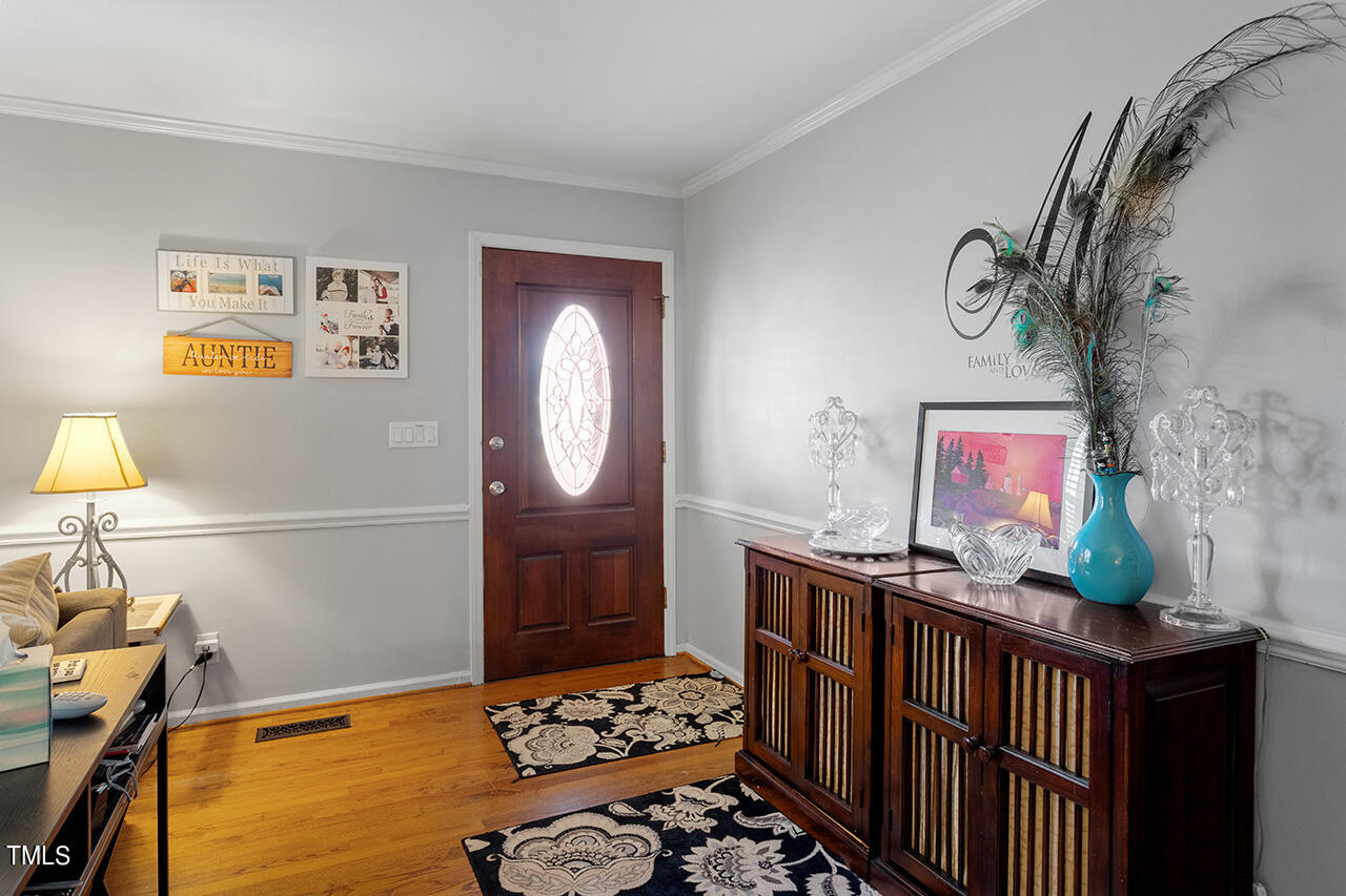 1660 Benson Road Angier, NC 27501 - Photo 8 of 32 a bedroom with furniture a rug and a window