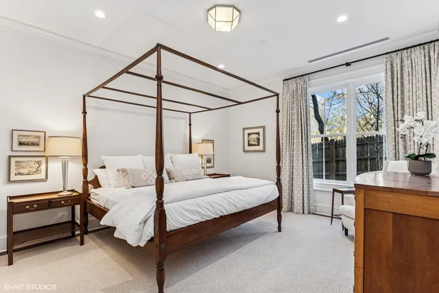 a bedroom with a bed and large window