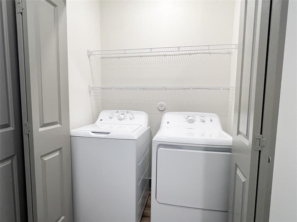 4020 McEwen Road, Unit 4106 Farmers Branch, TX 75244 - Photo 12 of 26 Laundry area with separate washer and dryer and wood finished floors