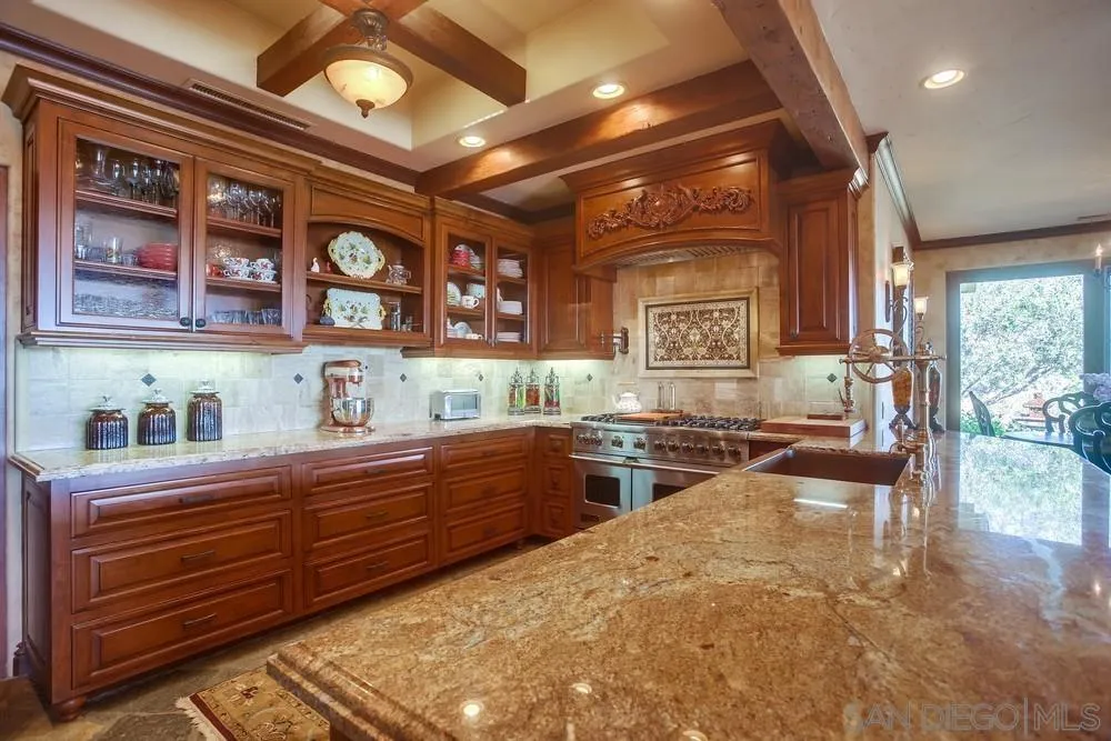 5653 Linea Del Cielo Rancho Santa Fe, CA 92067 - Photo 14 of 46 a kitchen with stainless steel appliances granite countertop a stove and cabinets