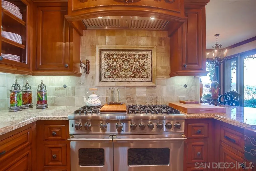 5653 Linea Del Cielo Rancho Santa Fe, CA 92067 - Photo 15 of 46 a kitchen with an oven a cabinets and a counter top space