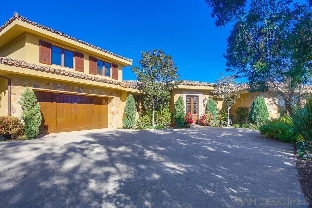 5653 Linea Del Cielo Rancho Santa Fe, CA 92067 - Photo 2 of 46 a view of yellow house with large windows and a large tree