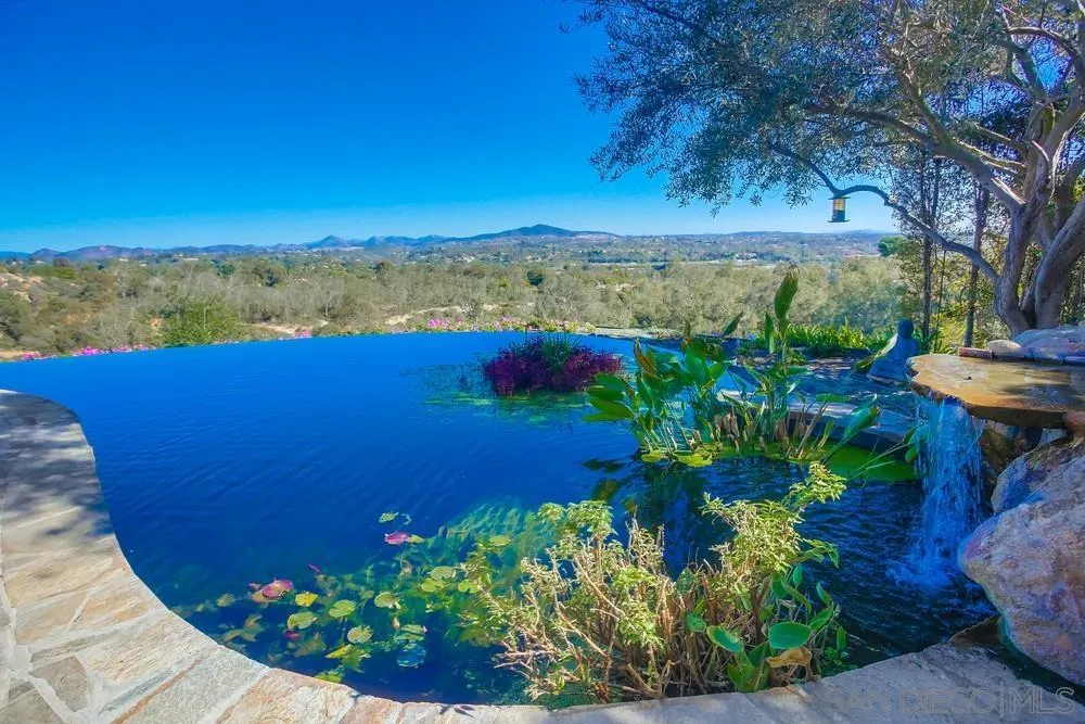 5653 Linea Del Cielo Rancho Santa Fe, CA 92067 - Photo 22 of 46 a view of a lake with a house in background