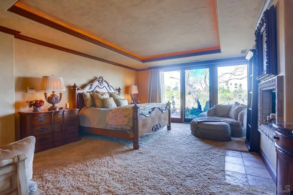 5653 Linea Del Cielo Rancho Santa Fe, CA 92067 - Photo 27 of 46 a bedroom with furniture and a large window
