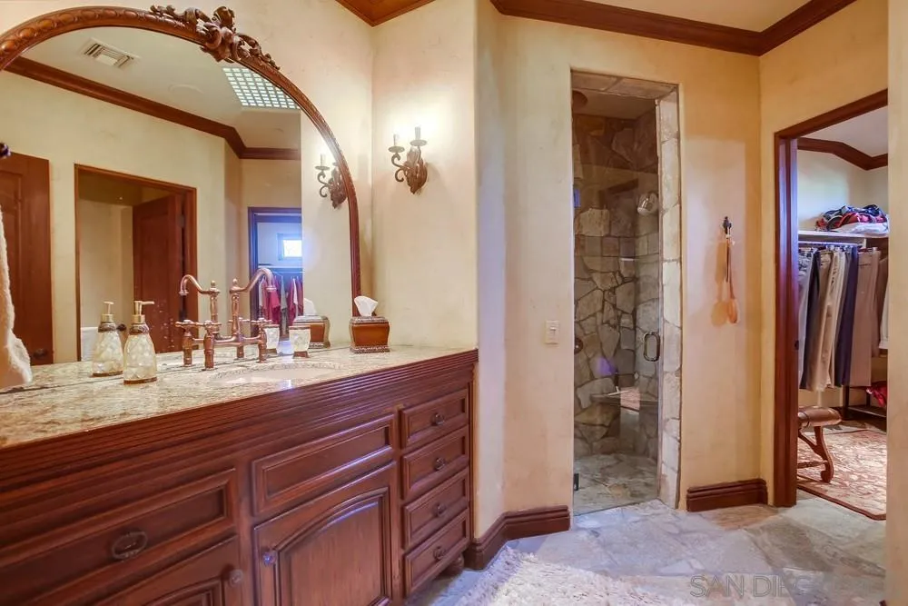5653 Linea Del Cielo Rancho Santa Fe, CA 92067 - Photo 29 of 46 a bathroom with a sink a mirror and a shower
