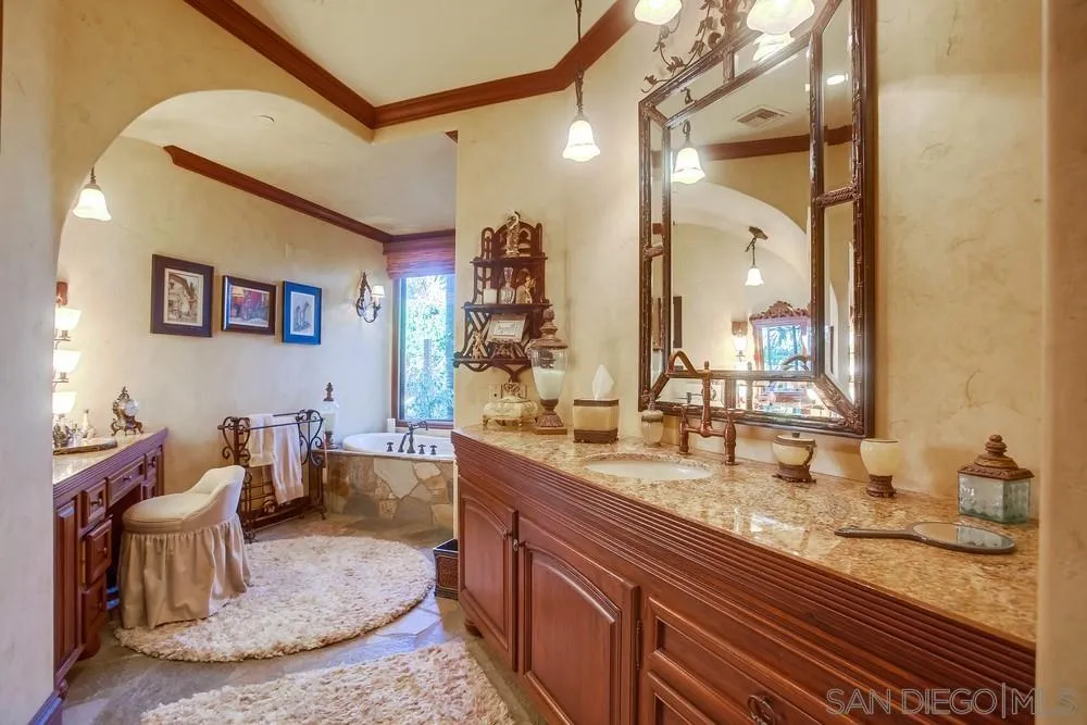 5653 Linea Del Cielo Rancho Santa Fe, CA 92067 - Photo 30 of 46 a bathroom with a granite countertop sink a toilet and a mirror