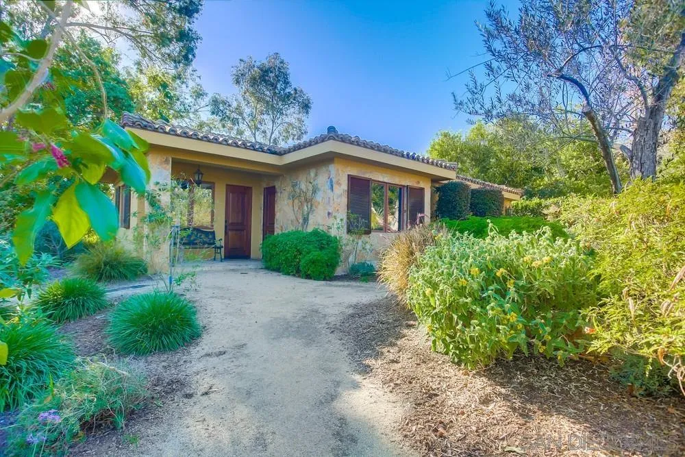 5653 Linea Del Cielo Rancho Santa Fe, CA 92067 - Photo 35 of 46 a front view of a house with a garden