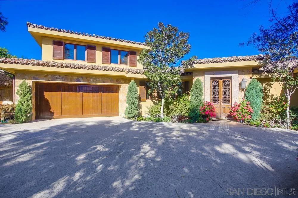 5653 Linea Del Cielo Rancho Santa Fe, CA 92067 - Photo 8 of 46 a view of a house with brick walls and a tree