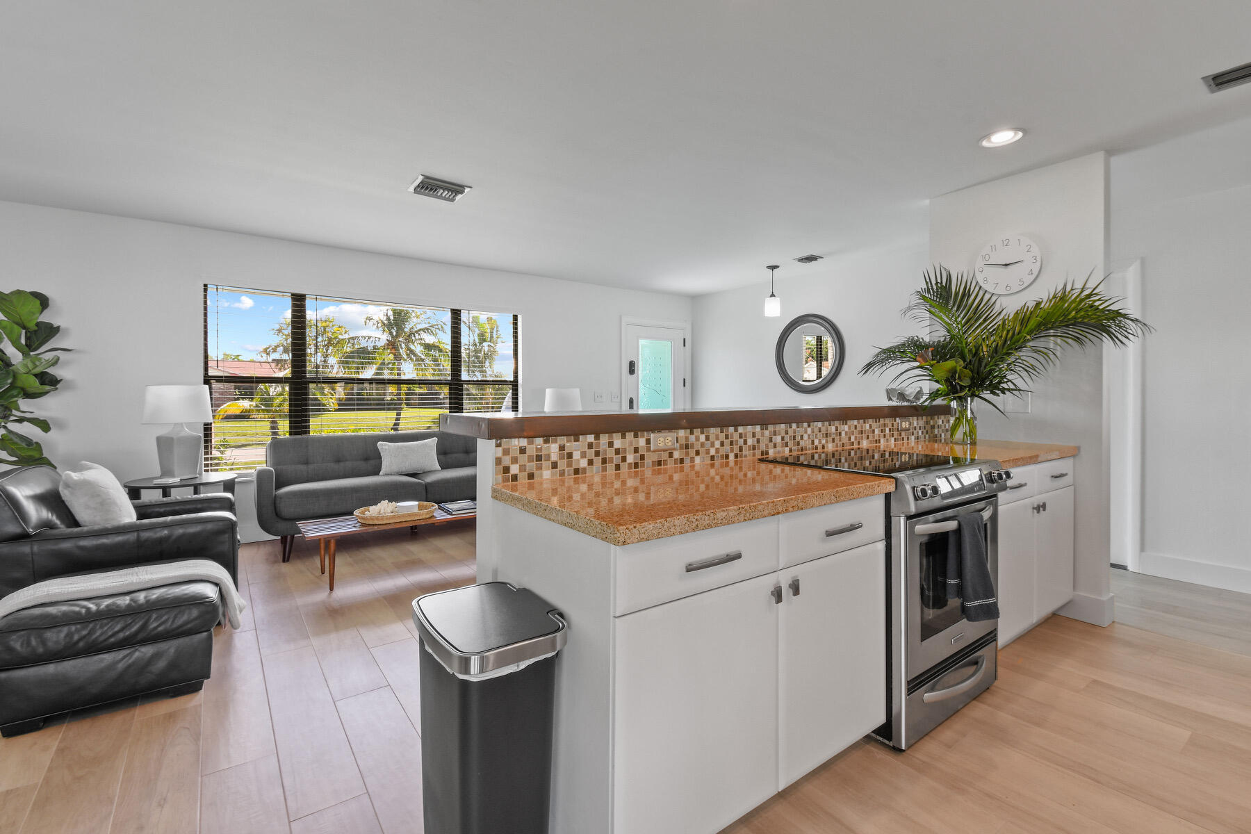 4153 Wingo Street Jupiter, FL 33469 - Photo 11 of 39 a view of a kitchen with furniture and wooden floor