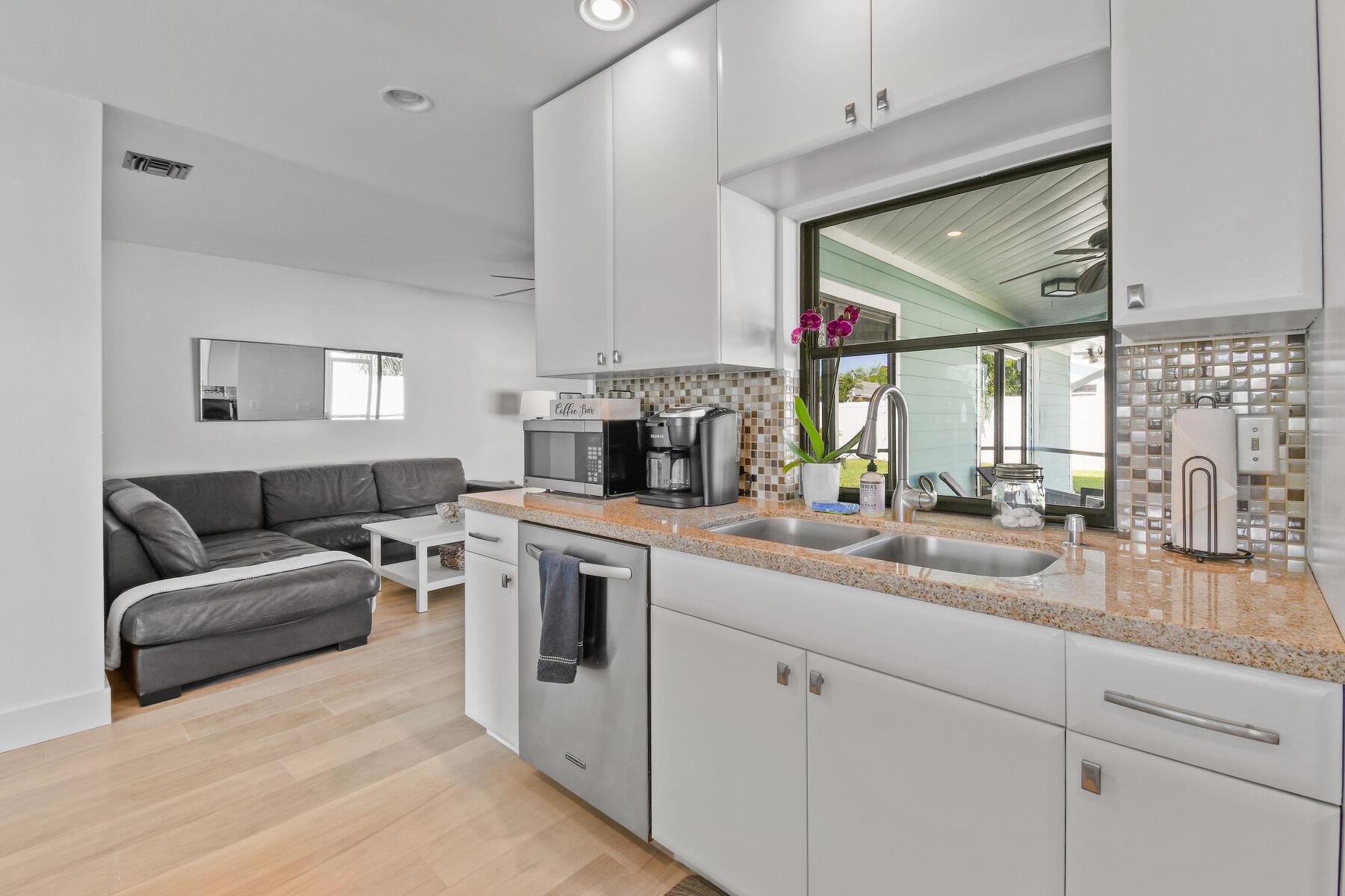 4153 Wingo Street Jupiter, FL 33469 - Photo 12 of 39 a kitchen with stainless steel appliances granite countertop a sink and a refrigerator