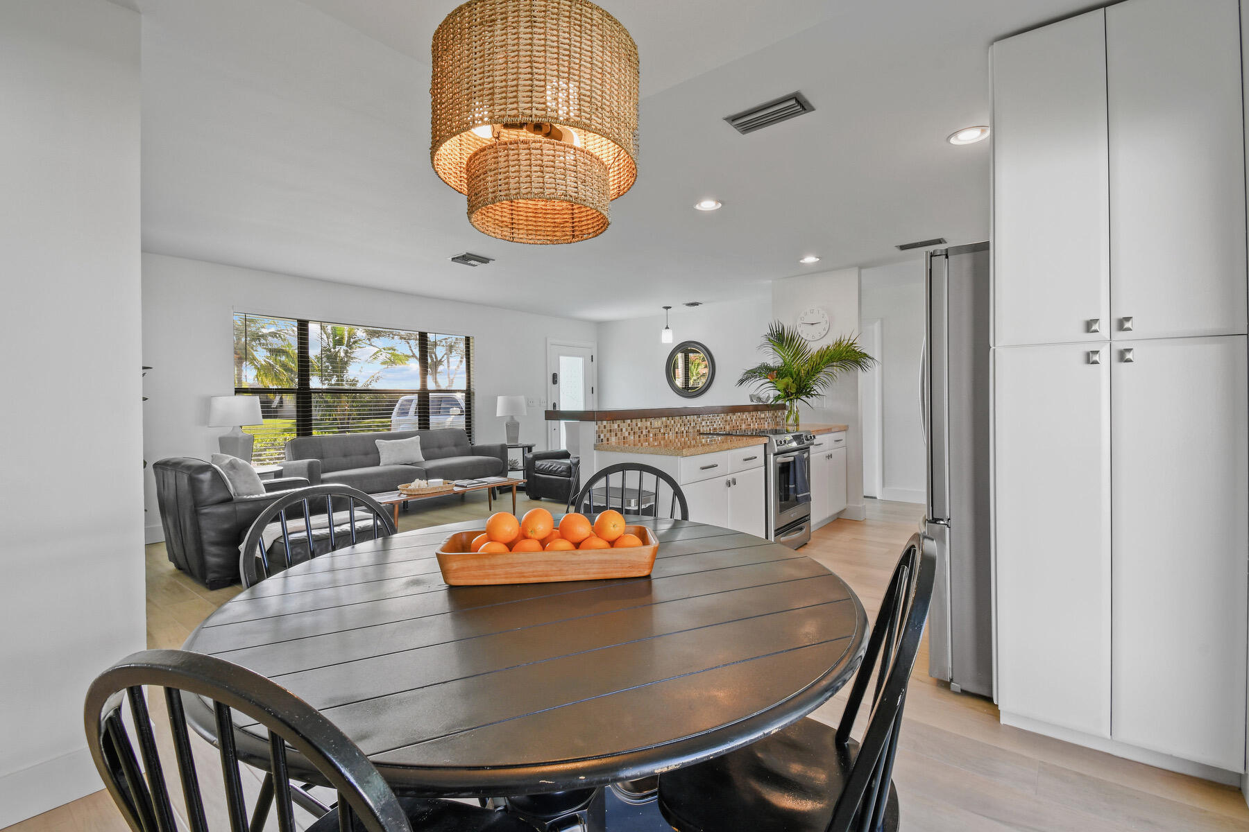 4153 Wingo Street Jupiter, FL 33469 - Photo 14 of 39 a view of a dining room with furniture and wooden floor