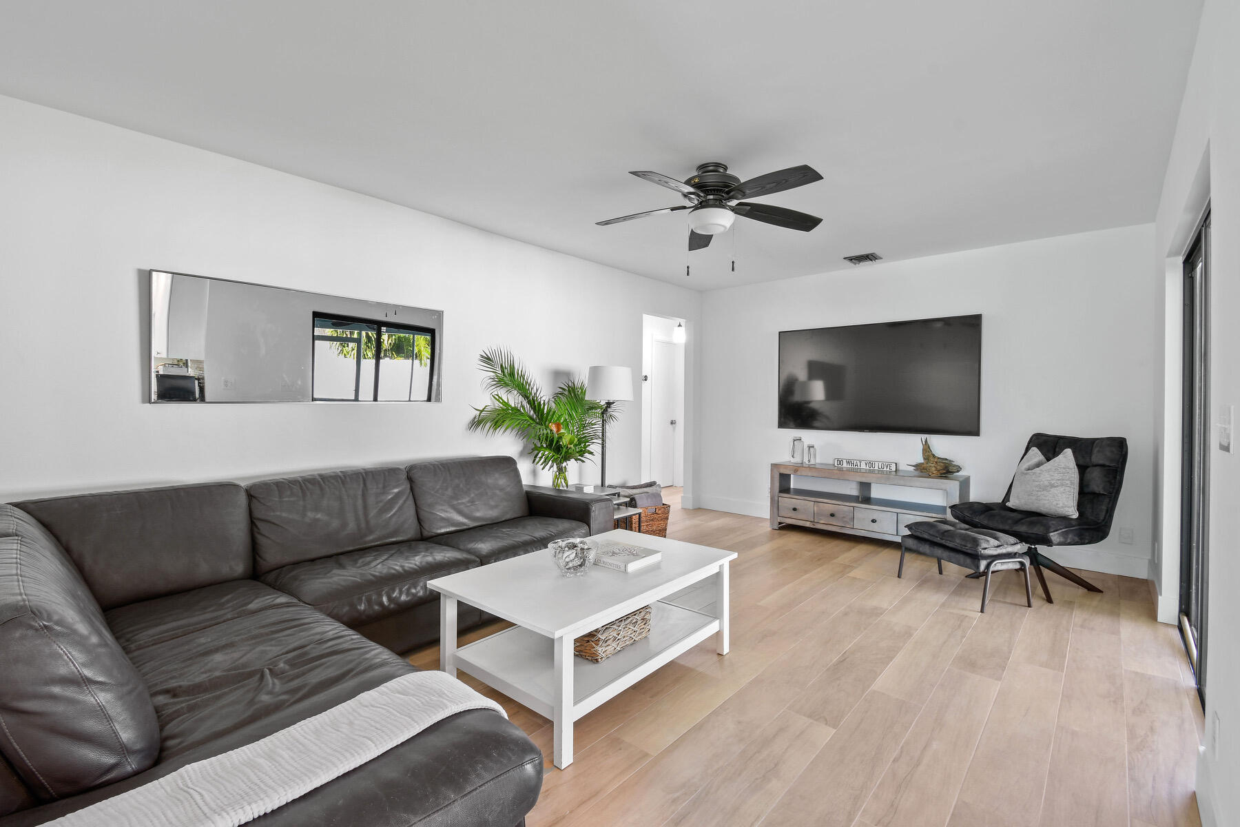 4153 Wingo Street Jupiter, FL 33469 - Photo 15 of 39 a living room with furniture and a flat screen tv