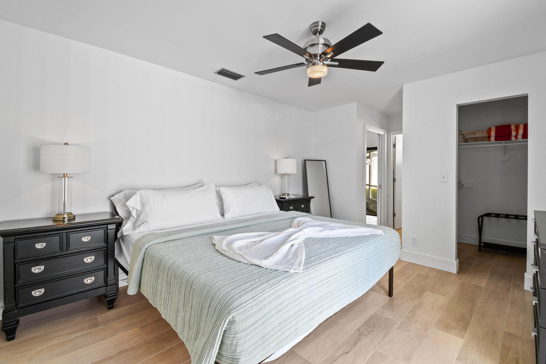 4153 Wingo Street Jupiter, FL 33469 - Photo 18 of 39 a bedroom with a bed and a ceiling fan