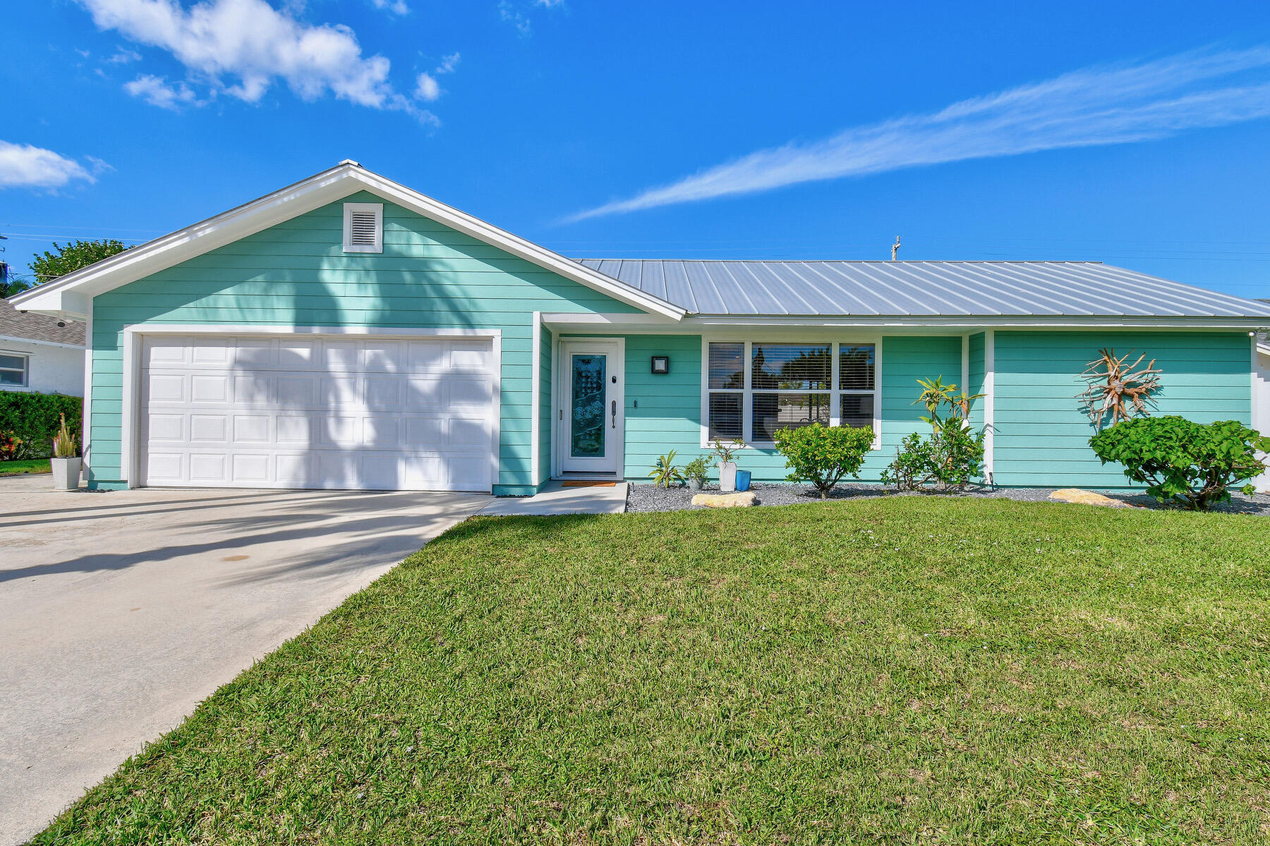 4153 Wingo Street Jupiter, FL 33469 - Photo 2 of 39 a front view of a house with garden