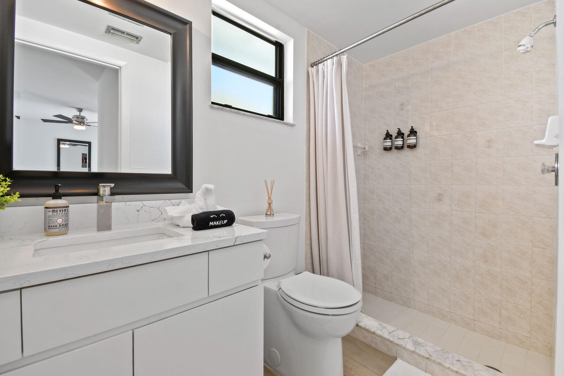 4153 Wingo Street Jupiter, FL 33469 - Photo 21 of 39 a bathroom with a sink a toilet and shower
