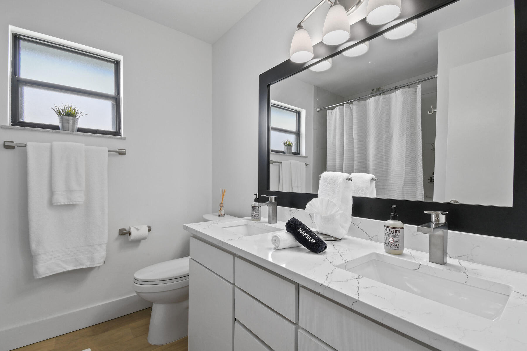 4153 Wingo Street Jupiter, FL 33469 - Photo 24 of 39 a bathroom with a double vanity sink mirror and toilet