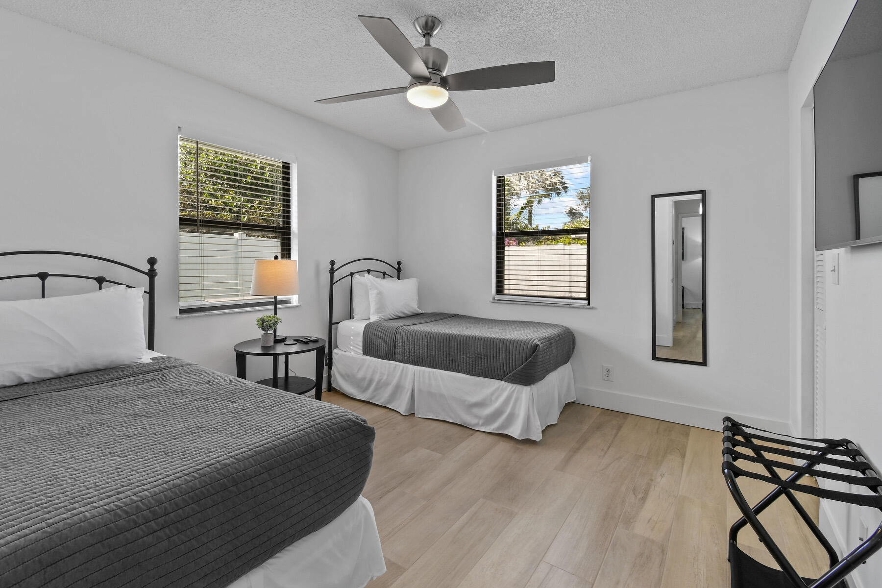 4153 Wingo Street Jupiter, FL 33469 - Photo 26 of 39 a bedroom with a bed and a window