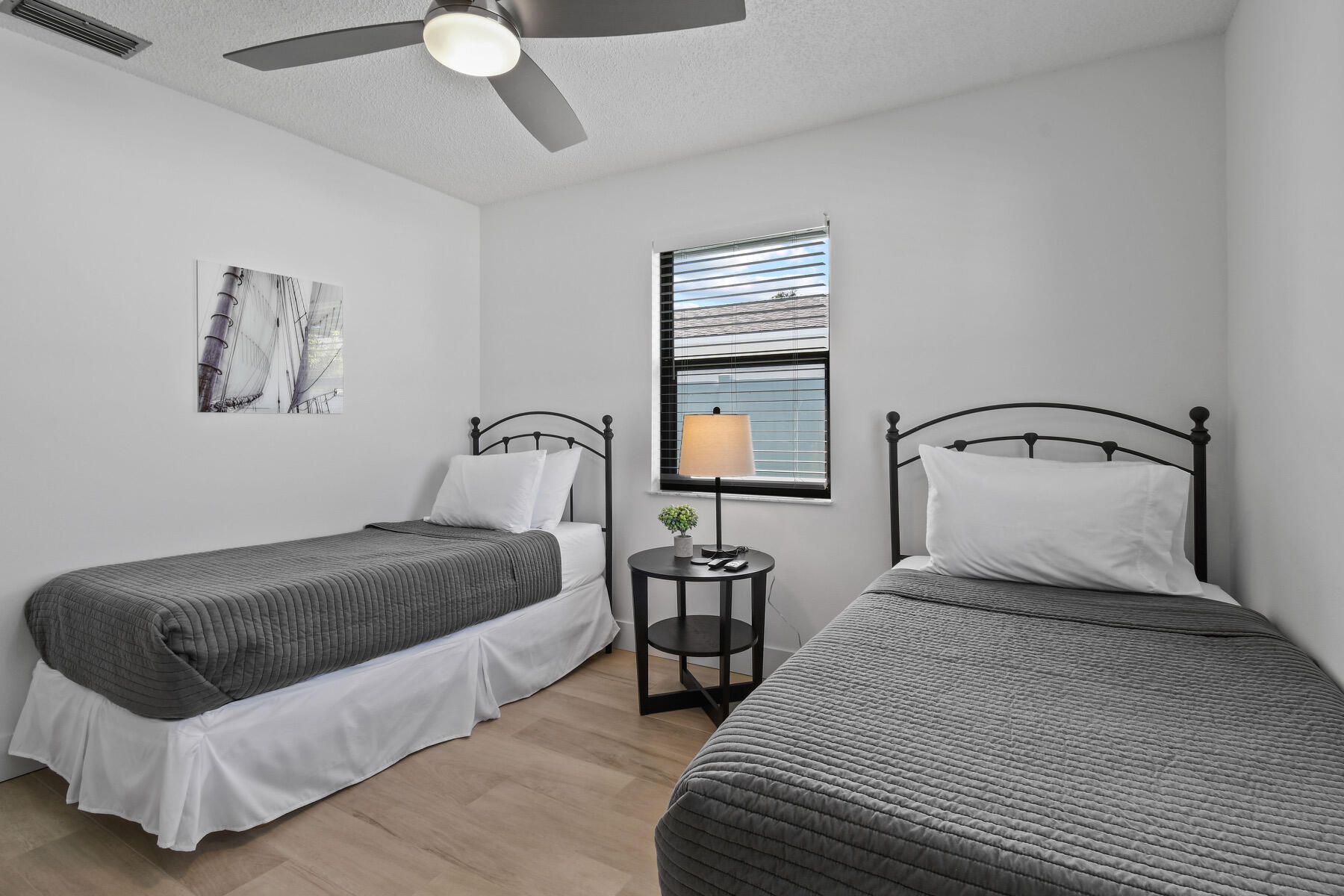 4153 Wingo Street Jupiter, FL 33469 - Photo 27 of 39 a bedroom with a bed and window