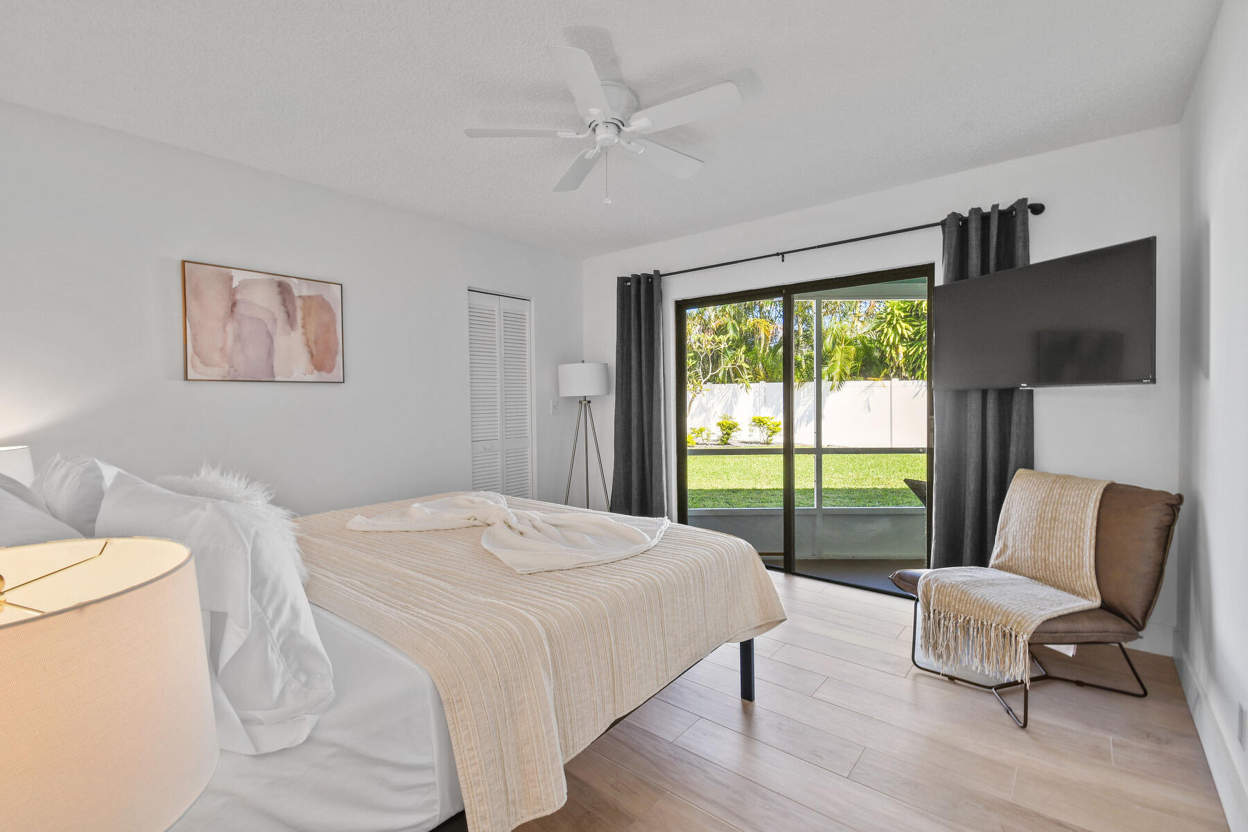 4153 Wingo Street Jupiter, FL 33469 - Photo 28 of 39 a bedroom with a bed and a couch