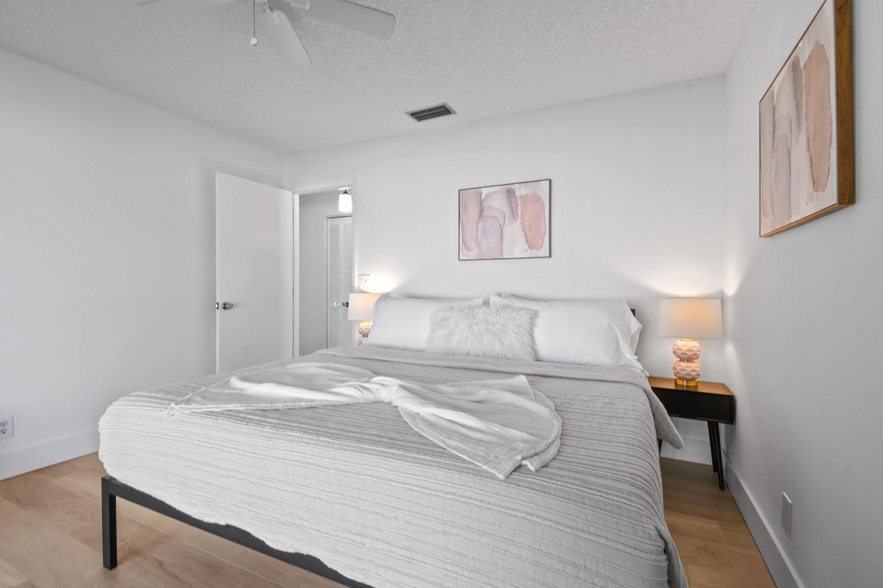 4153 Wingo Street Jupiter, FL 33469 - Photo 29 of 39 a bedroom with a bed and a wall painting