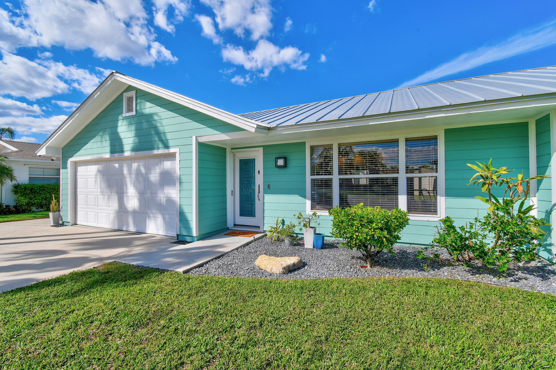 4153 Wingo Street Jupiter, FL 33469 - Photo 3 of 39 front view of a house with a yard